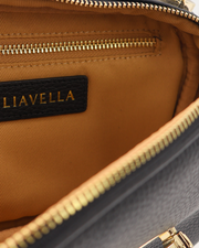 Close-up of a the beige internal lining of an AVAIA Petit bag in noir bag with gold zipper and LIAVELLA branding.
