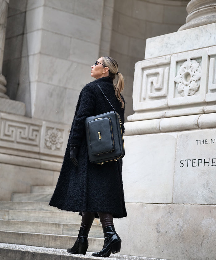 Person wearing the AVAIA Noir as a shoulder bag on a city street