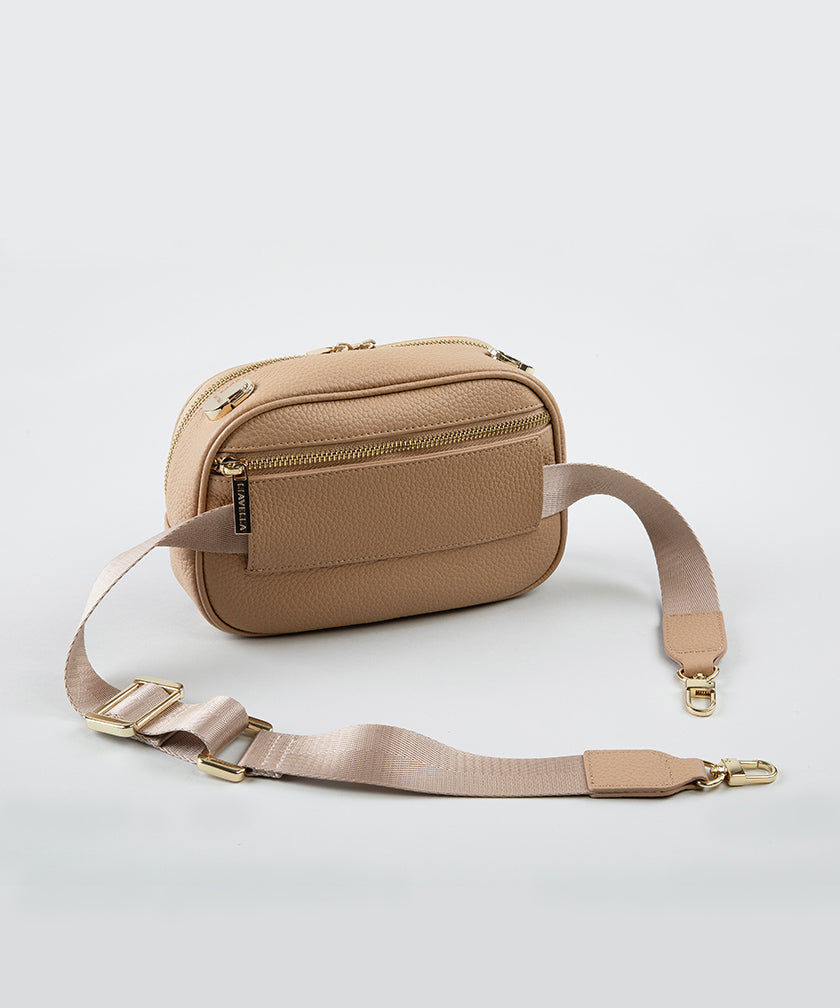 The passthrough strap of a crème caramel AVAIA Petit bag, with the fabric strap that for bumbags.