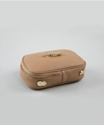Load image into Gallery viewer, The bottom side edge of a crème caramel AVAIA Petit bag, on a studio background.