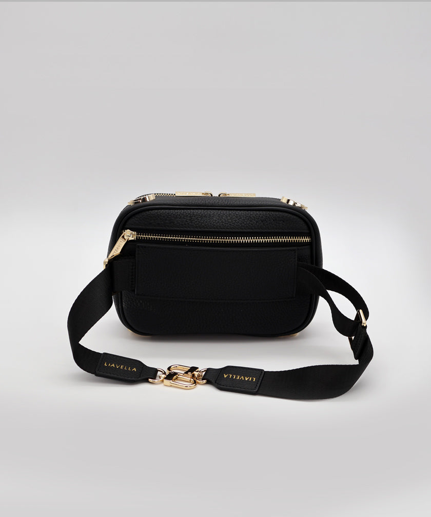 The passthrough strap of a noir AVAIA Petit bag, with the fabric strap that for bumbags.