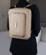 Load image into Gallery viewer, The AVAIA bag worn as a backpack on a woman wearing a black jacket.