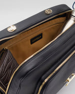 Load image into Gallery viewer, Black leather AVAIA handbag with gold zippers and hardware, featuring the brand LIAVELLA.