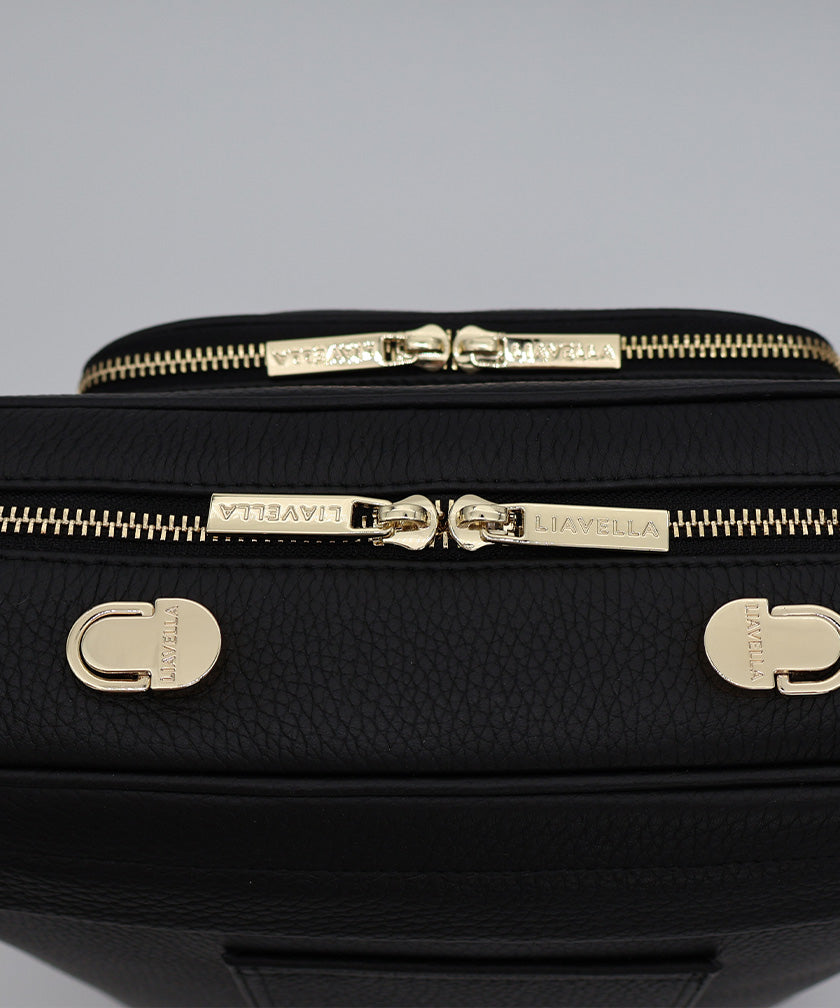 Close-up shot of the pebbled leather and gold hardware on the AVAIA bag.