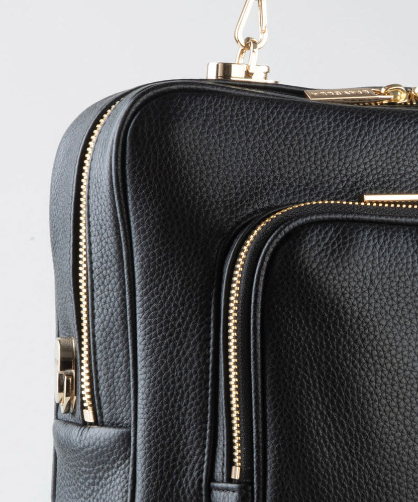 Close-up shot of the pebbled leather and gold hardware on the AVAIA bag.
