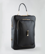 Load image into Gallery viewer, Noir AVAIA bag, with a handheld leather strap and gold accents on a light gray background