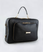 Load image into Gallery viewer, The LIAVELLA signature AVAIA bag in Noir featuring a wrist strap in the same colour, against a white background.
