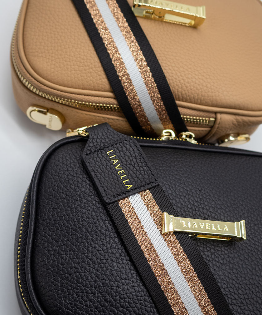 Two AVAIA Petit bags both with striped fabric straps, positioned next to each other against a light gray background.