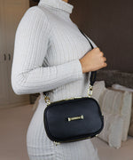 Load image into Gallery viewer, Person wearing a gray sweater with an AVAIA Petit bag over her shoulder, clearly showing the LIAVELLA branding.
