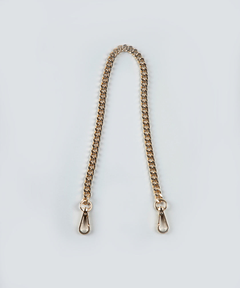 The Petit gold chain strap with gold hardware on a light gray background.