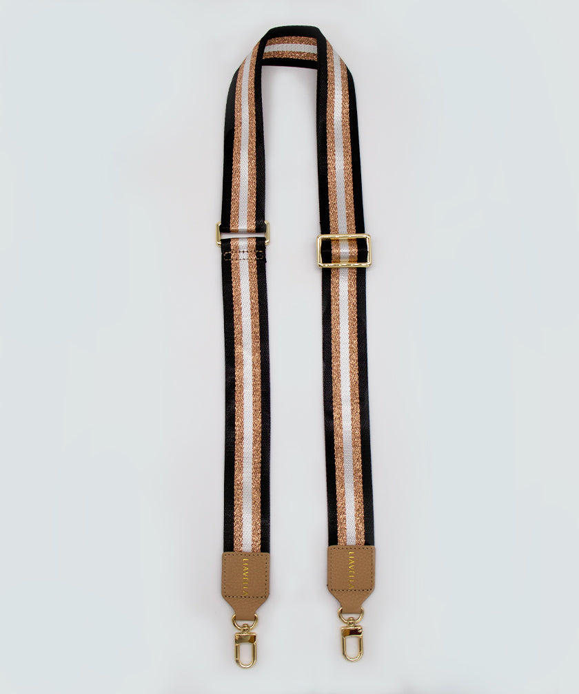 Striped strap with gold hardware on a white background.