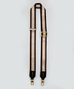 Load image into Gallery viewer, A single strap that is striped with gold accents and black trim on a white background.

