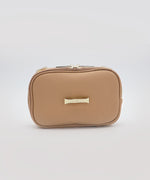 Load image into Gallery viewer, The AVAIA Petit without a strap, showing the branded &quot;LIAVELLA&quot; gold hardware, against a rey background.
