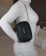 Load image into Gallery viewer, Woman wearing a ribbed grey sweater and an AVAIA Petit bag over the shoulder with a gold chain strap.
