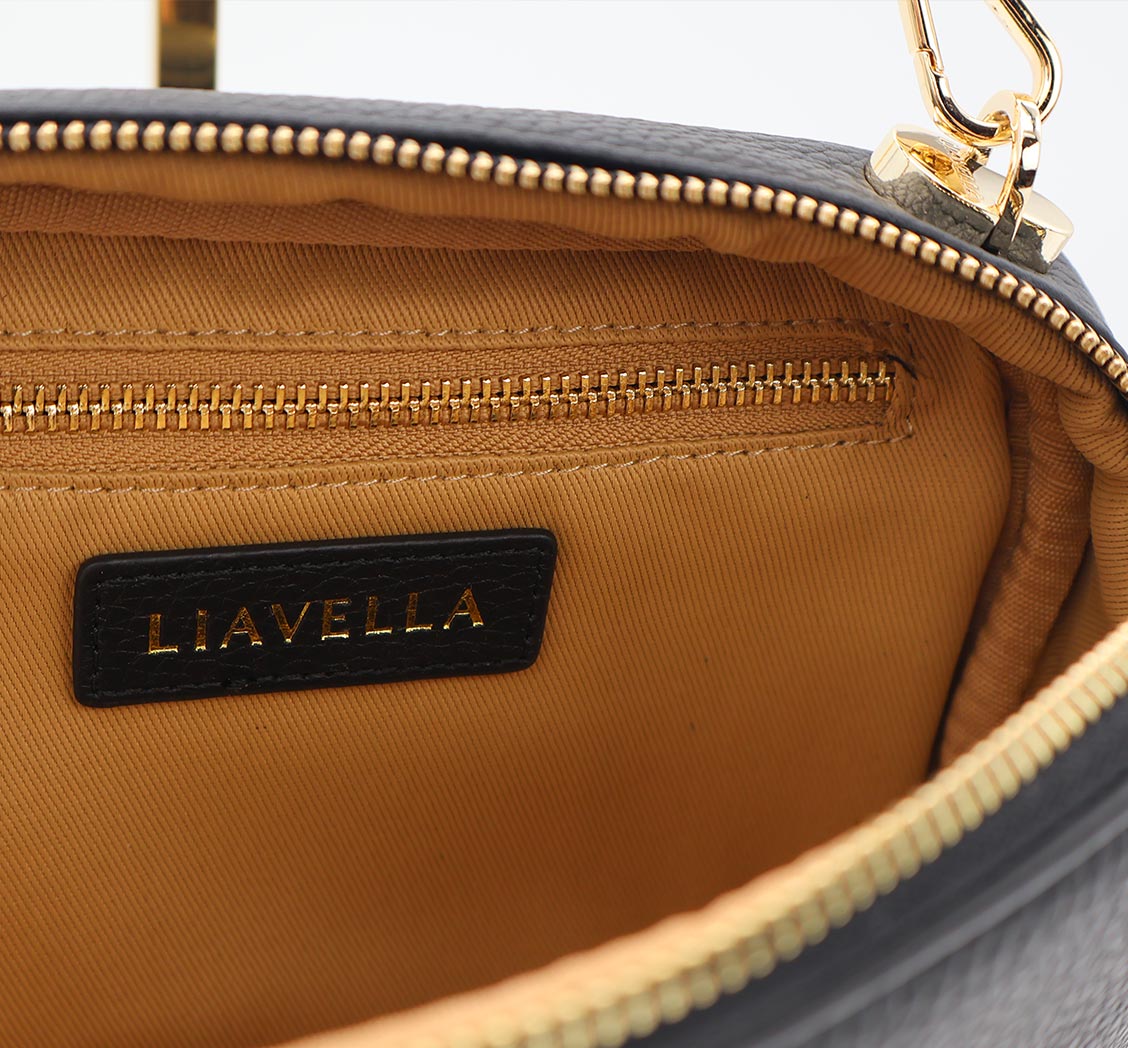 Close-up of a LIAVELLA bag with gold zipper and beige interior.